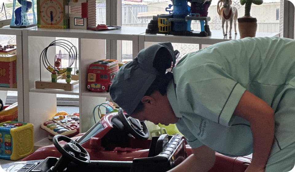 GLD team member in green uniform working on sustainable hygiene equipment in a bright facility